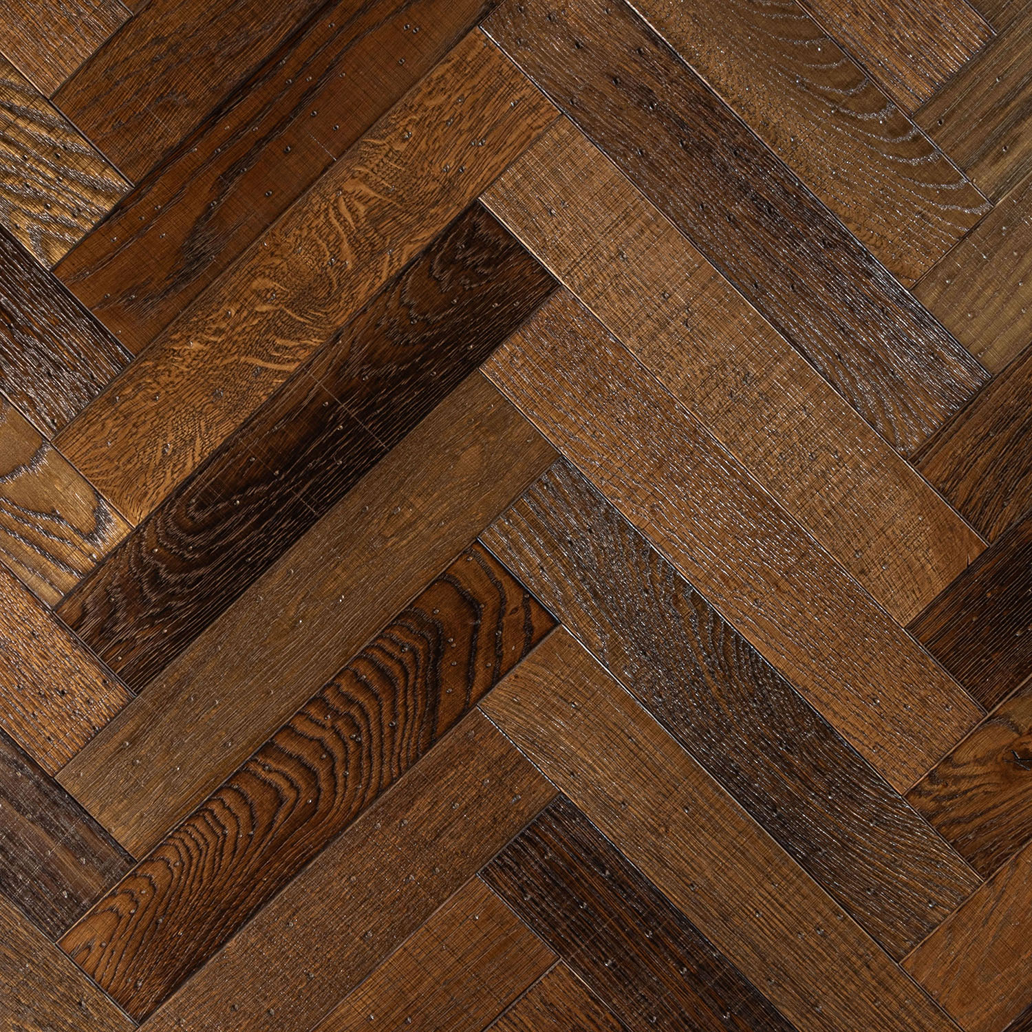 Beaumont Avenue golden oak herringbone flooring with sawn marks and tumbled edges.