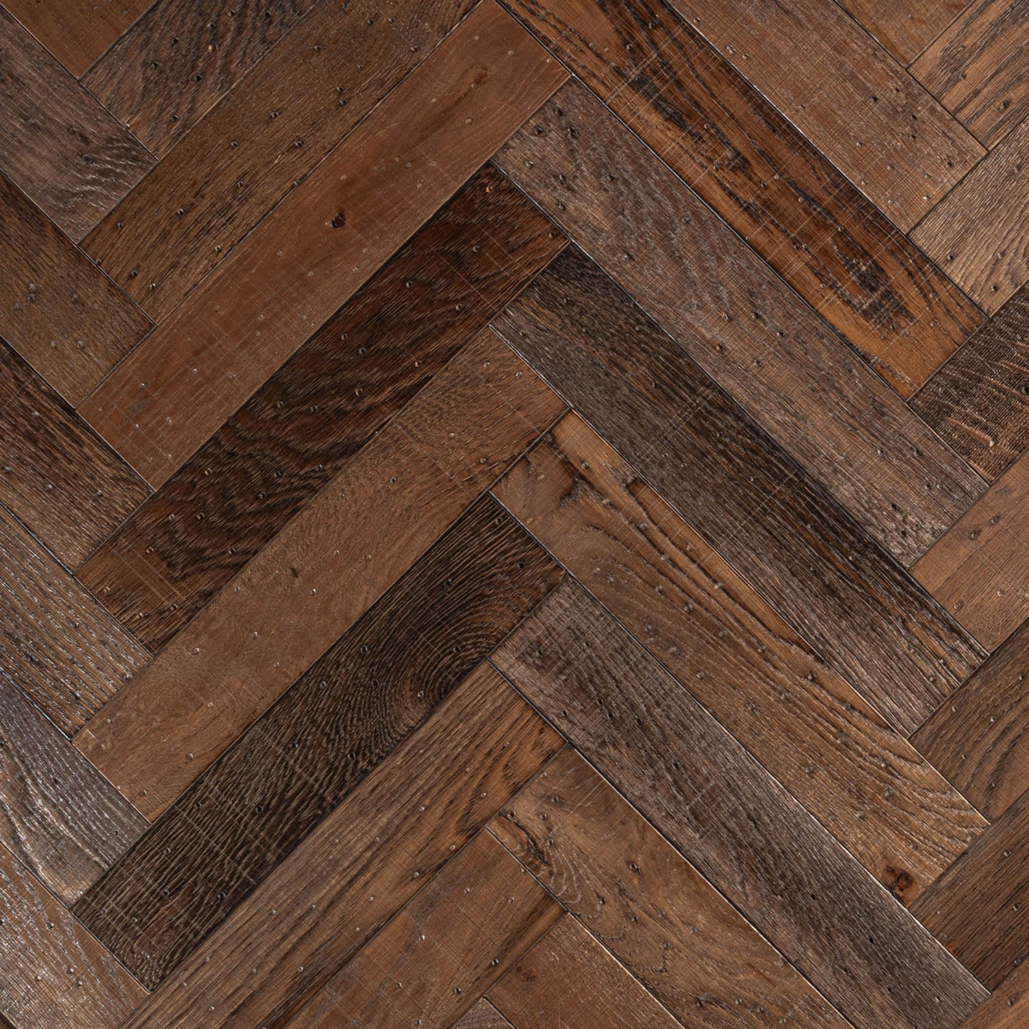 Wilfred Gardens weathered grey-wash engineered oak herringbone flooring.