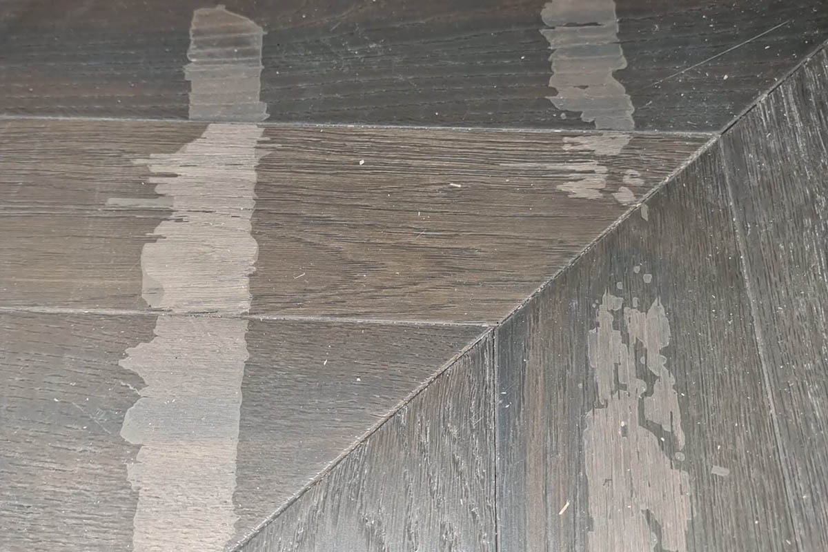 Damaged caused by sticky tape on a new wood floor