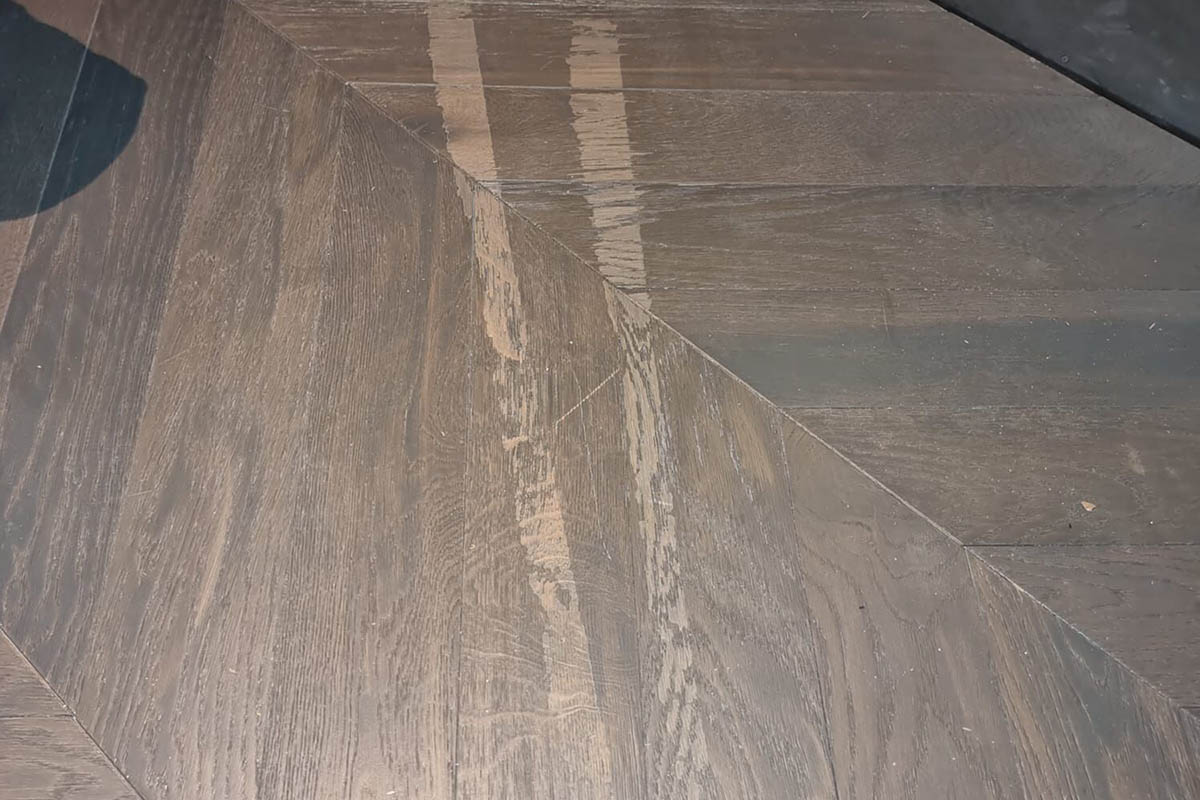 Damaged caused by sticky tape on a new wood floor