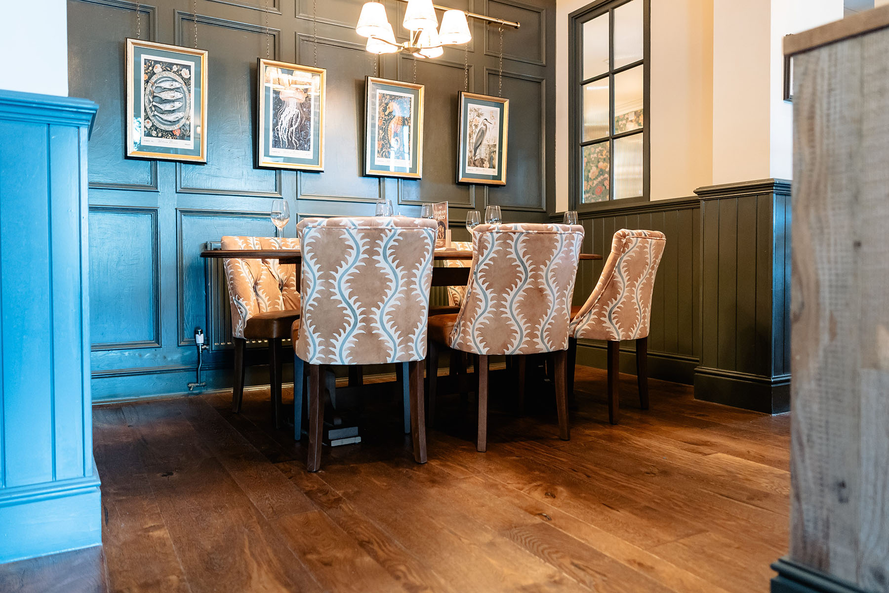Mixed width hand-distressed oak floorboards in Llandudno pub interior.