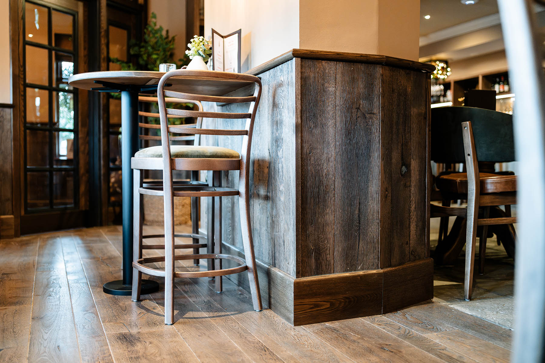 Rustic oak wall panelling paired with mixed-width wood flooring