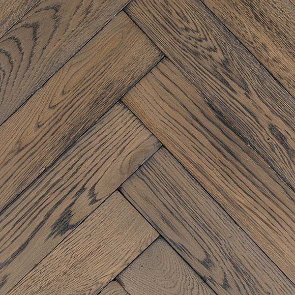 Solid oak herringbone wood floor with distressed and worn texture finished with UV oil