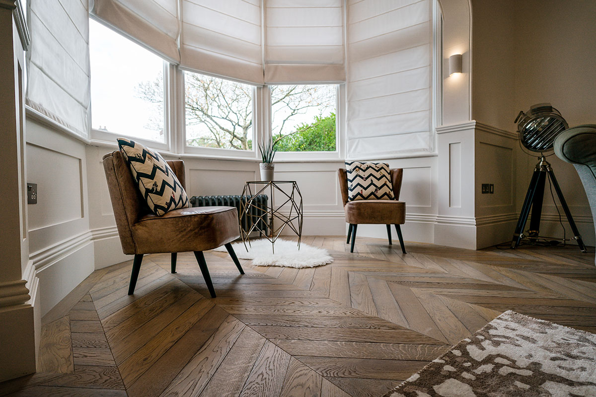 Chevron engineered oak wood flooring in a home living room.
