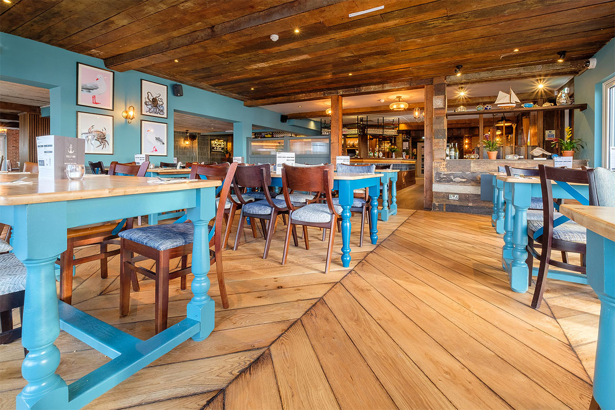 Engineered wood flooring with a large chevron design in a restaurant.