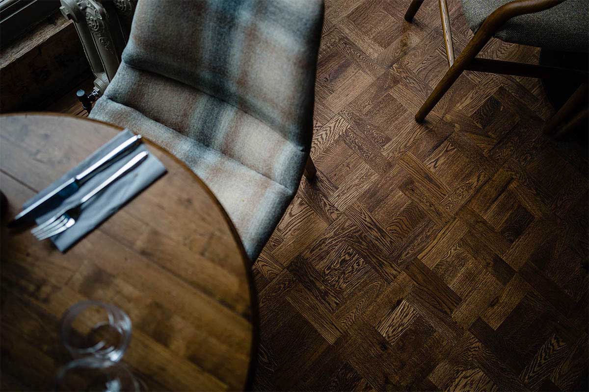 Engineered wood flooring with a parquet design in a restaurant.