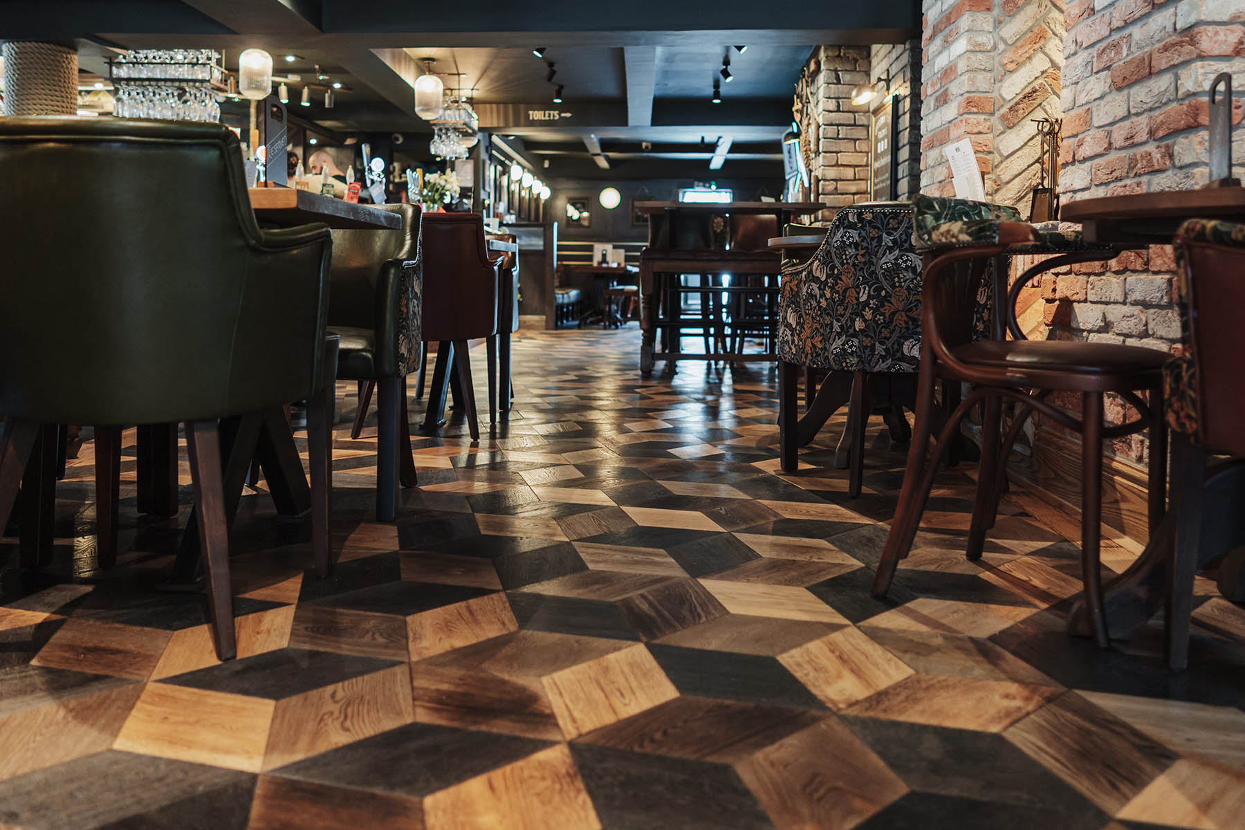 Pub interior featuring bespoke diamond and herringbone oak flooring by JackEvie