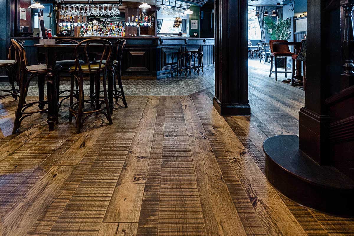 Rustic mixed width wood floor inside a traditional pub.