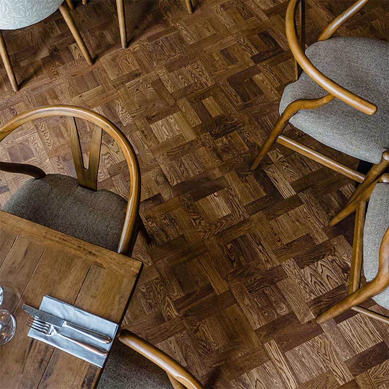 Geometric parquet wood flooring suitable for commercial spaces