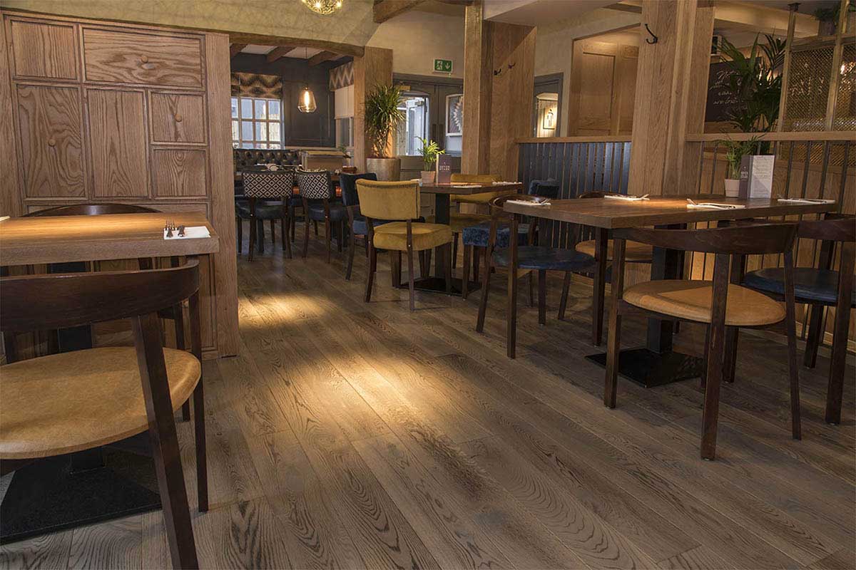 Engineered plank wood flooring installation in a new restaurant.
