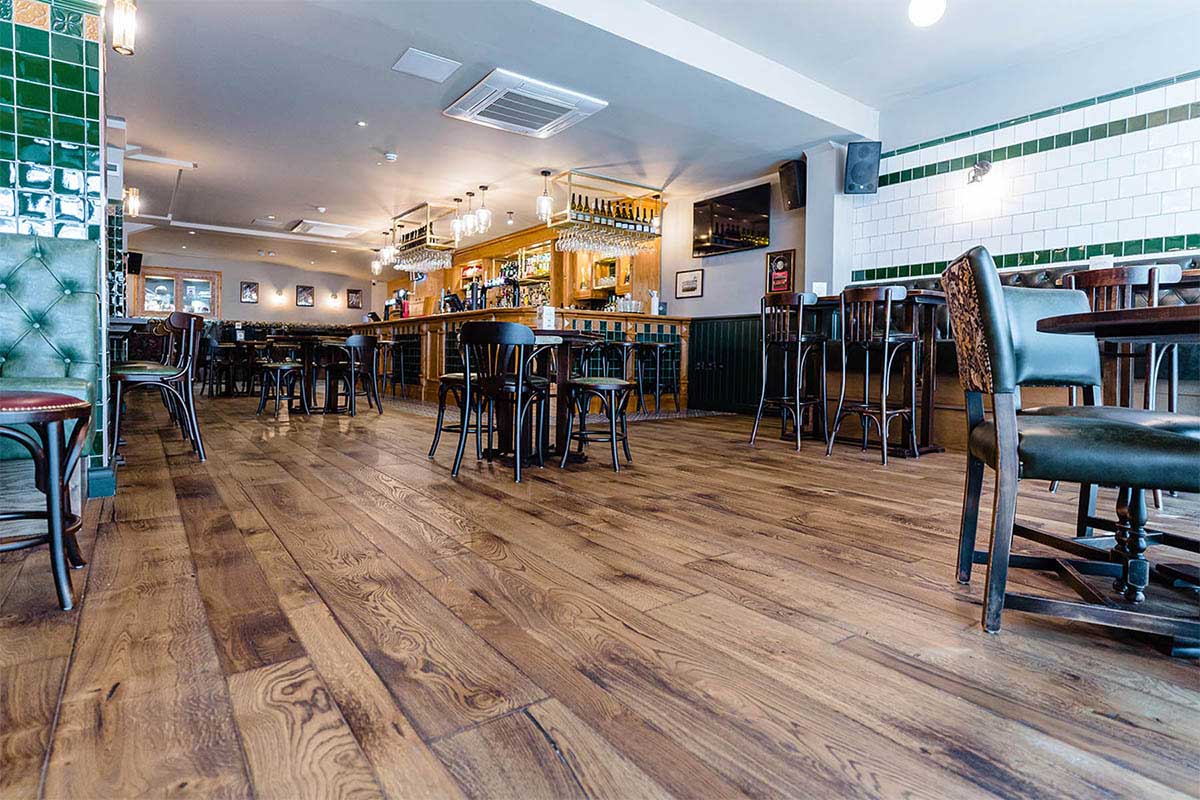 Mixed width wood flooring in commercial setting.