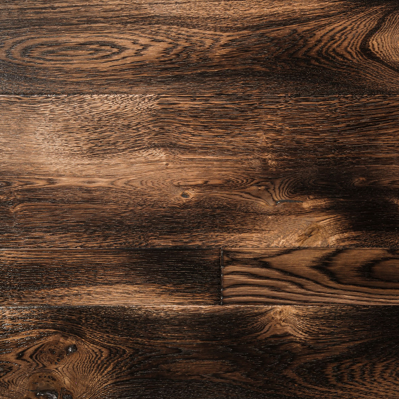 ◦ Clematis Drive torched smoked oak flooring with charred tones.